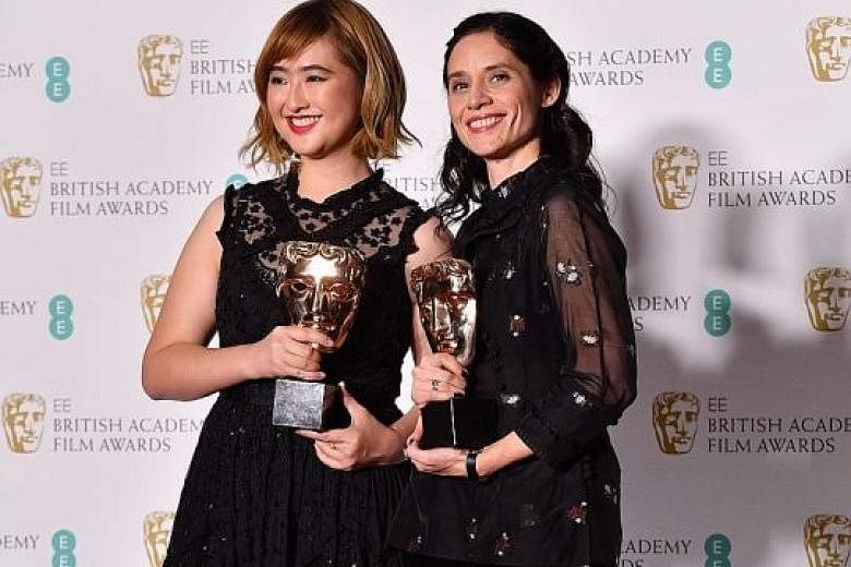 Producer Low Ser En and British director Paloma Baeza (both above) with their awards for the film Poles Apart at Royal Albert Hall in London on Sunday.