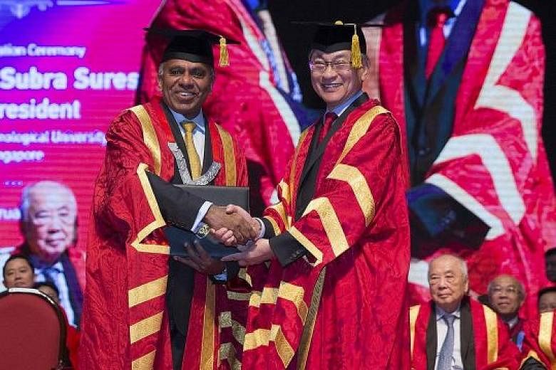 NTU president Subra Suresh receiving his conferment as distinguished university professor from Mr Koh Boon Hwee, chairman of the NTU board of trustees, at the inauguration ceremony at the university's Nanyang Auditorium yesterday.