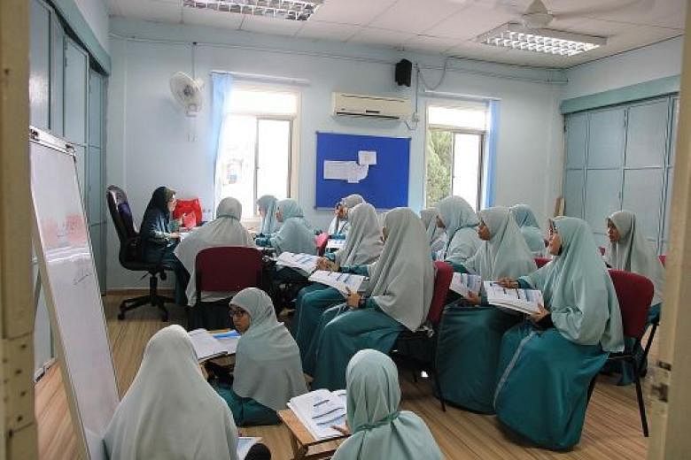 Students at a tahfiz school in Malaysia, where they have to memorise the Quran. They do not study maths, science or technical subjects. 