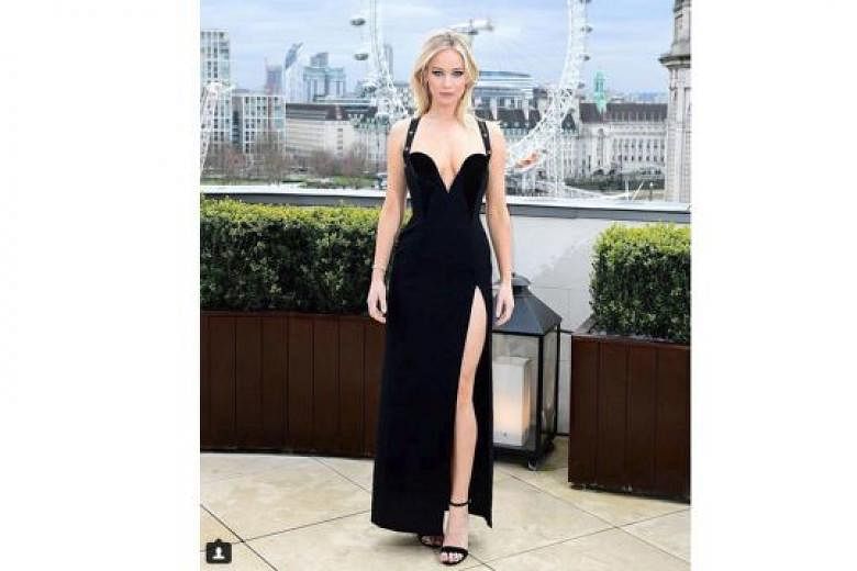 Jennifer Lawrence's black dress (above) brings to mind a similar gown that actress Elizabeth Hurley wore in 1994 (with actor Hugh Grant) - both are by Versace and feature a plunging neckline and a high slit. 