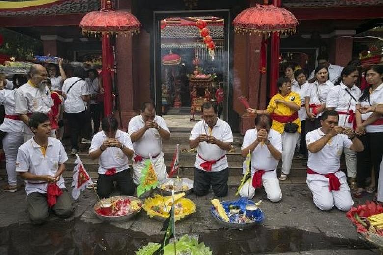 Ethnic Chinese-Indonesians praying during Chinese New Year celebrations at a temple in Bali last week. Years ago, under former president Suharto's policy of assimilation, everything connected to Chinese culture and language was forbidden, and Chinese