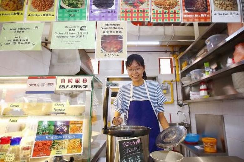 Green Rice Bowl stallholder Ng Qin Rong at her stall in Holland Drive Market and Food Centre. Ms Ng said NEA's Incubation Stall Programme "helped me take the leap of faith because it was a lot cheaper and less risky".