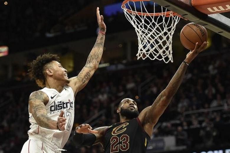 Cleveland forward LeBron James driving to the rim against Washington forward Kelly Oubre Jr at Quicken Loans Arena. Poor three-point shooting was a factor in the Cavaliers' 103-110 loss.