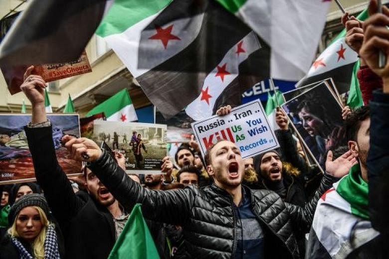 Protesters in front of the Russian consulate in Istanbul on Thursday during a demonstration against the air strikes and shelling by Syrian government forces in Ghouta. The writer says the external powers which had earlier been entrusted with the resp