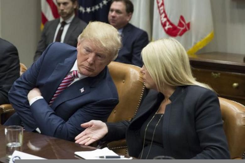 Florida Attorney-General Pam Bondi with Mr Donald Trump at a meeting with local and state officials on school safety on Thursday. Mr Trump has suggested arming a significant portion of the educator workforce - between 10 and 40 per cent of teachers -