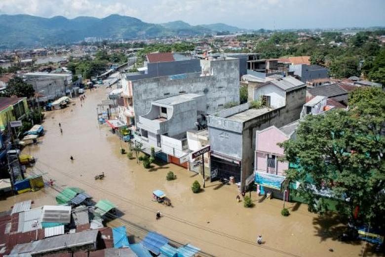 Above: Dayeuhkolot Street in Bandung was flooded yesterday after the Citarum River, the third-longest river on Java island, broke its banks. 