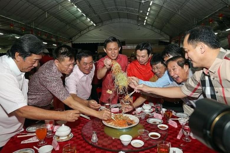 Minister in the Prime Minister's Office Chan Chun Sing (centre) and MP for Tanjong Pagar GRC Chia Shi-Lu (in red) join residents in lo hei at the annual Tanjong Pagar GRC and Radin Mas SMC Lunar New Year Dinner yesterday.