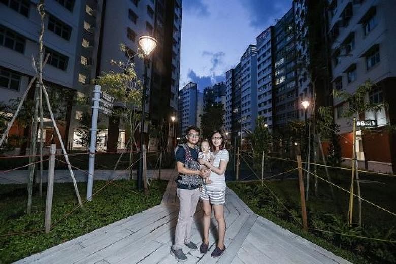 Mr Adrian Tay and his wife Joan Tan, with their year-old daughter Kiersten, at their new place in Admiralty Grove.