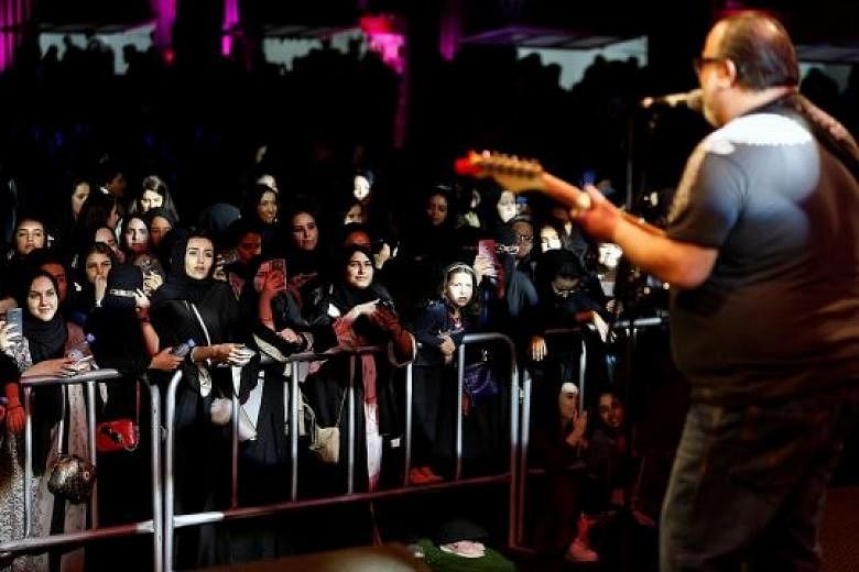 Women and children at Saudi Arabia's first jazz festival in Riyadh on Friday. Despite the persisting restrictions - men and women were still confined to different sections apart from family areas - the three-day music festival marks a change in socia