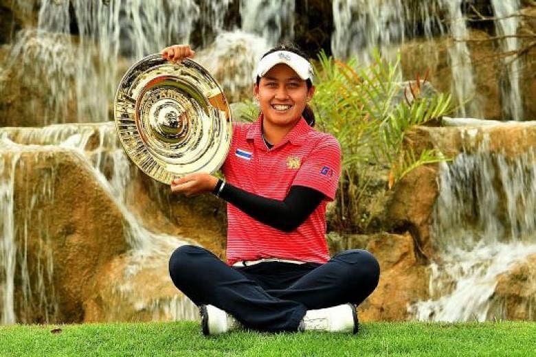 Thai teenager Atthaya Thitikul showing off her trophy after winning the Women's Amateur Asia-Pacific c'ship following a four-way play-off at Sentosa Golf Club's New Tanjong Course yesterday.