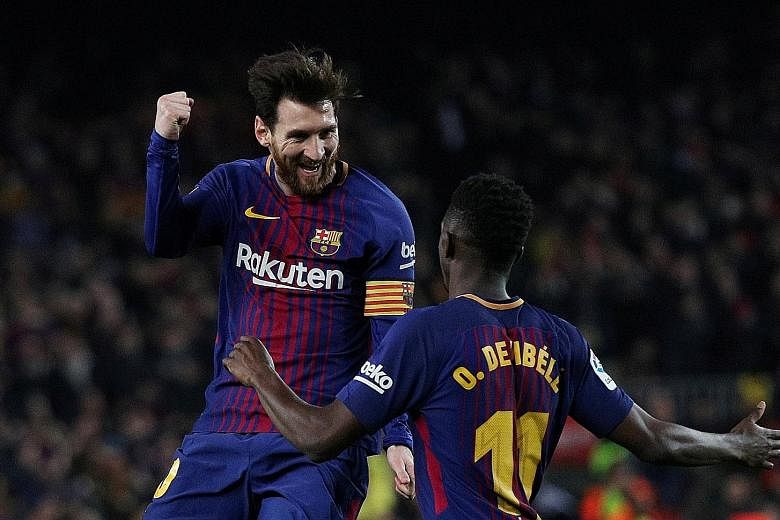 Barcelona's Lionel Messi celebrates scoring their third goal with Ousmane Dembele. Off a free kick, he hit the ball under the defensive wall instead of over it.