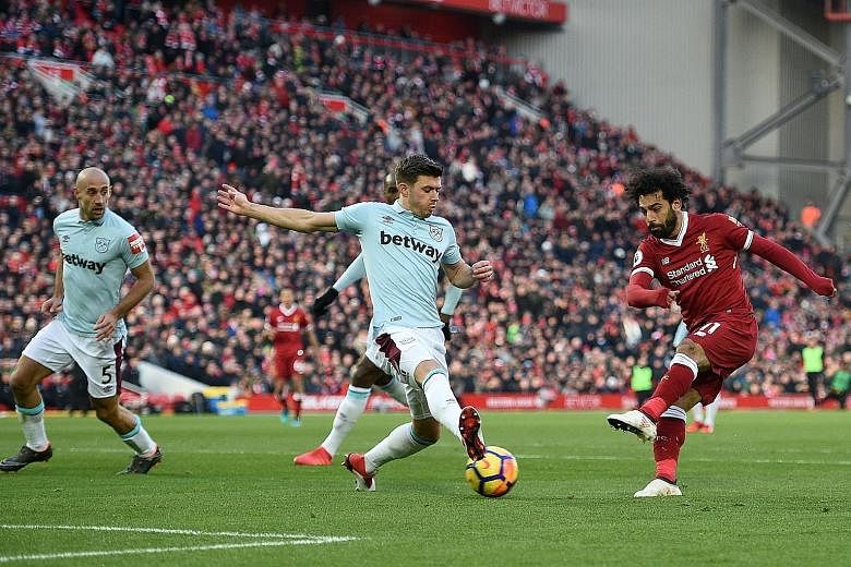 Liverpool's Mohamed Salah shooting between Aaron Cresswell's legs to score Liverpool's second goal against West Ham. He also took the corner from which team-mate Emre Can opened the scoring, bringing the Egyptian's league tally to 23 goals and eight 