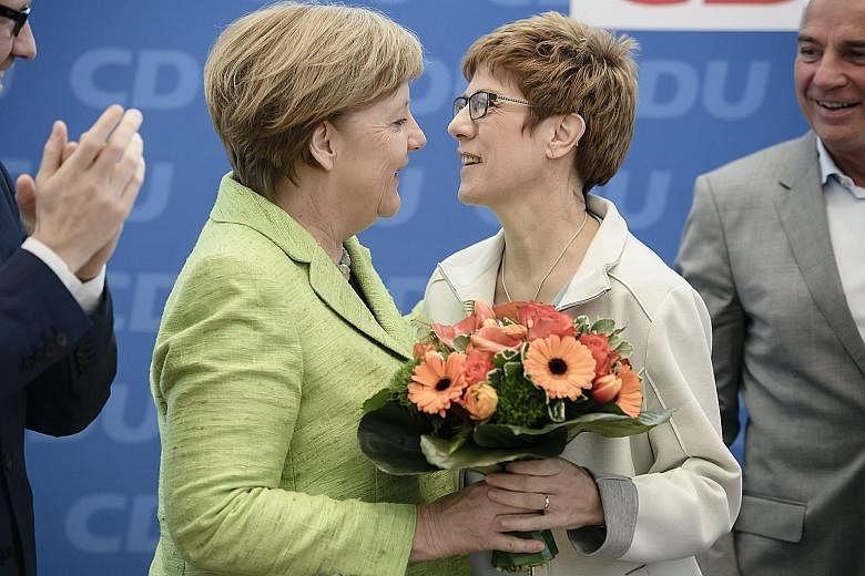 Mrs Annegret Kramp-Karrenbauer and German Chancellor Angela Merkel at a CDU board meeting in Berlin last year. Last Monday, Dr Merkel nominated Mrs Kramp-Karrenbauer as the CDU's secretary-general. The premier of the south-western border state of Saa