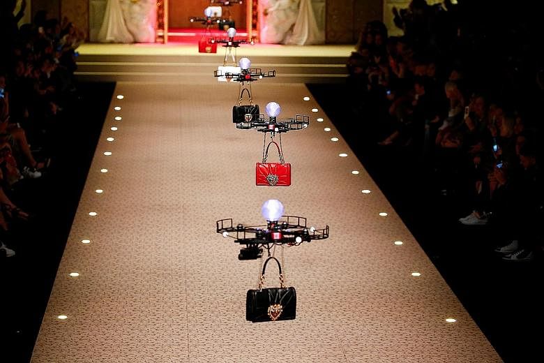 Designers to the stars Dolce & Gabbana opened the gates of fashion heaven on Sunday in a spectacular show, one of the last events of Milan Fashion Week. At the show's start, bells chimed, golden gates opened and drones flew out, carrying the brand's 