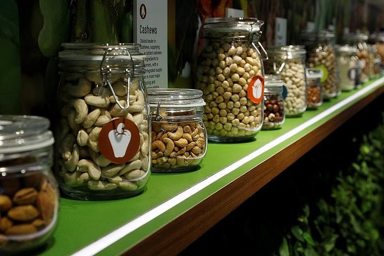 Jars of Olam's products, such as almonds, cashews and peanuts, displayed at its office in Singapore last year. The company is using sensors in its almond plantations in California and Australia to improve water-use efficiencies.