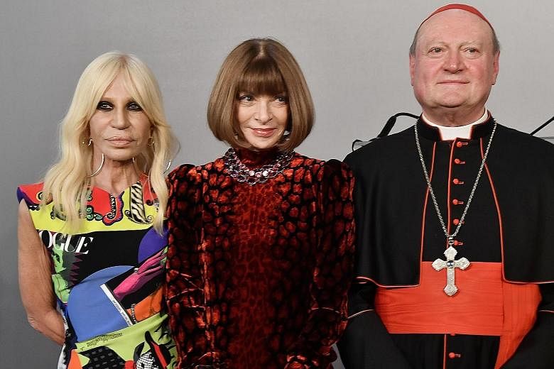 (From left) Italian designer Donatella Versace, Vogue editor-in-chief Anna Wintour and Cardinal Gianfranco Ravasi at the Palazzo Colonna for the preview of the exhibition, Heavenly Bodies: Fashion And The Catholic Imagination.