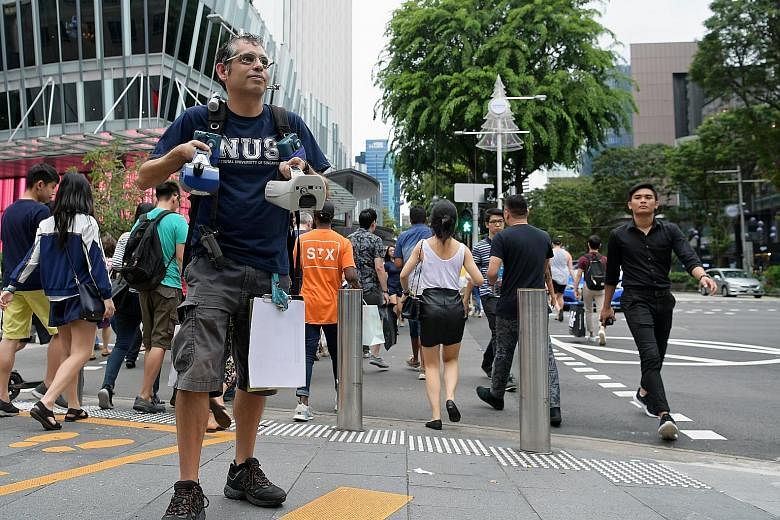 Dr Erik Velasco with air quality measurement devices at Orchard Road. His study found that commuters travelling via bus or taxi breathed in up to two times more harmful particles compared with taking the MRT.