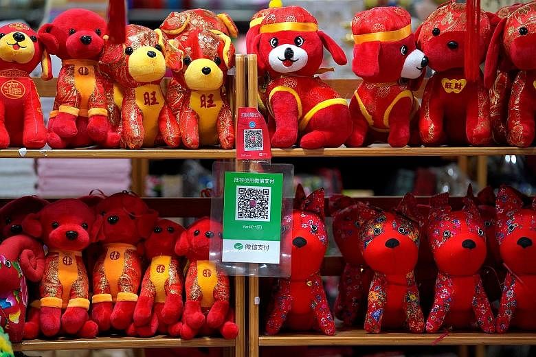 QR codes for WeChat Pay - developed by Tencent - and Alibaba payment platform Alipay at a toy shop in Beijing. The sheer size of Tencent and Alibaba and their increasingly world-spanning ambitions have made rivalry inevitable, says the writer.