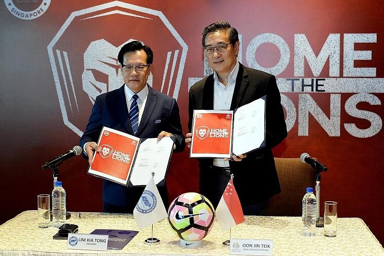 Football Association of Singapore president Lim Kia Tong (far left) and Singapore Sports Hub CEO Oon Jin Teik at yesterday's MOU signing ceremony. National footballers will get to train and play more often on the National Stadium pitch.