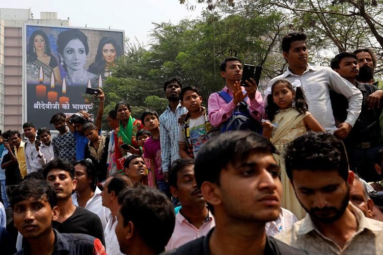Fans of Bollywood actress Sridevi waiting to pay their last respects outside a makeshift memorial in the Indian city of Mumbai yesterday. The legendary actress drowned in the bathtub after losing consciousness late last Saturday in a hotel in Dubai, 