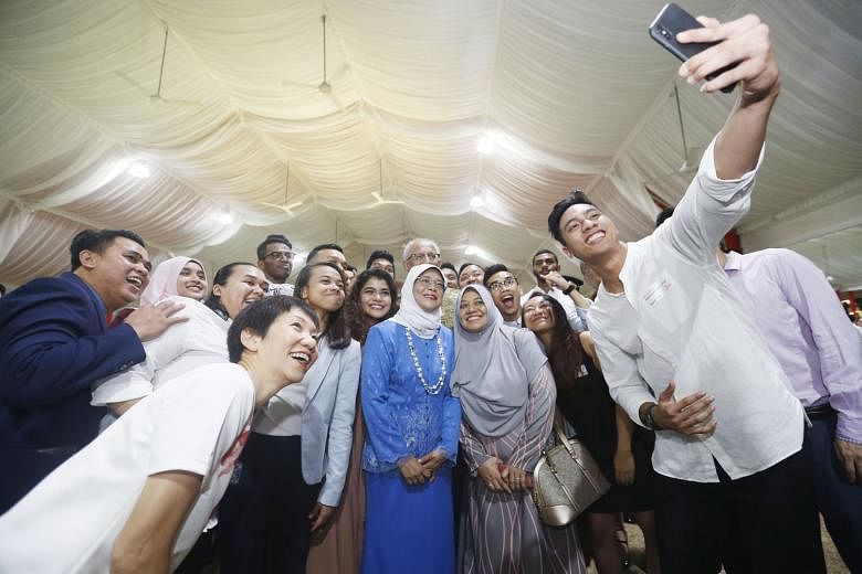 President Halimah Yacob and Minister for Culture, Community and Youth Grace Fu taking a wefie with a group of athletes during a dinner reception at the Istana last night.