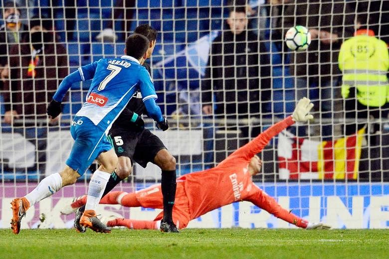 Espanyol forward Gerard Moreno scoring the game's only goal past Real goalkeeper Keylor Navas and defender Raphael Varane deep in stoppage time on Tuesday. It was Real's fifth LaLiga loss this season. 