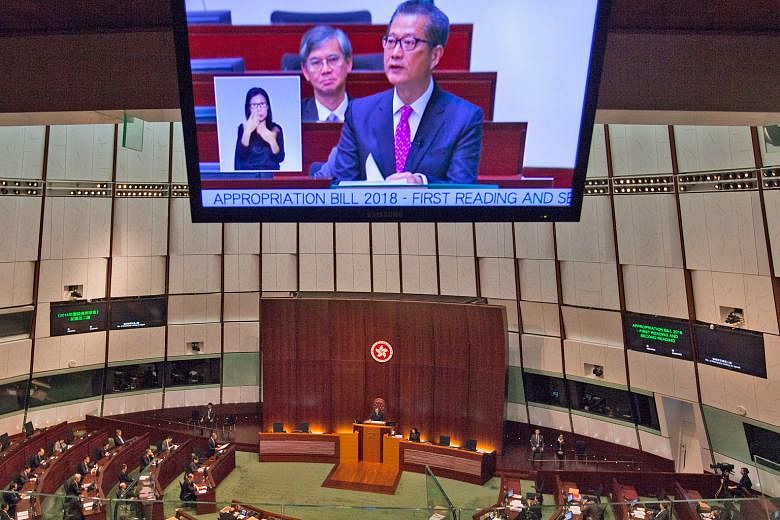 Financial Secretary Paul Chan presenting the Hong Kong Budget for 2018 at the city's Legisaltive Council yesterday.