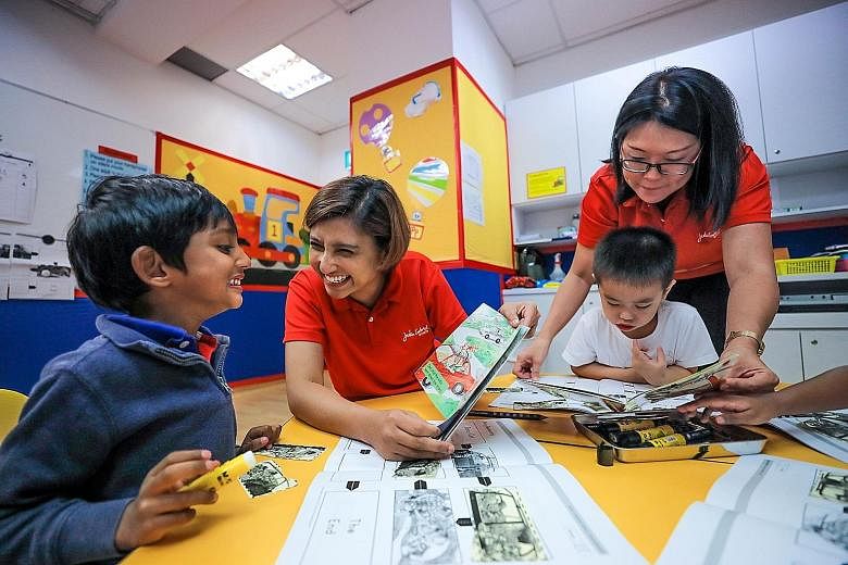 Kindergarten 1 children Raghav Swaminathan and Brandon Foo Fang Wei enjoying reading with teachers Naziahaseen Mohamed Nazir (seated) and Audrey Chew during a weekly reading programme at the Julia Gabriel Centre at The Forum last week. Pupils in Sing