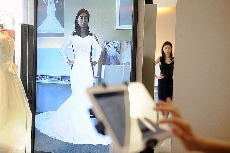 At La Belle Couture, women can try on 20 gowns in a minute using FX Mirror, an augmented reality system involving 3D visualisation.