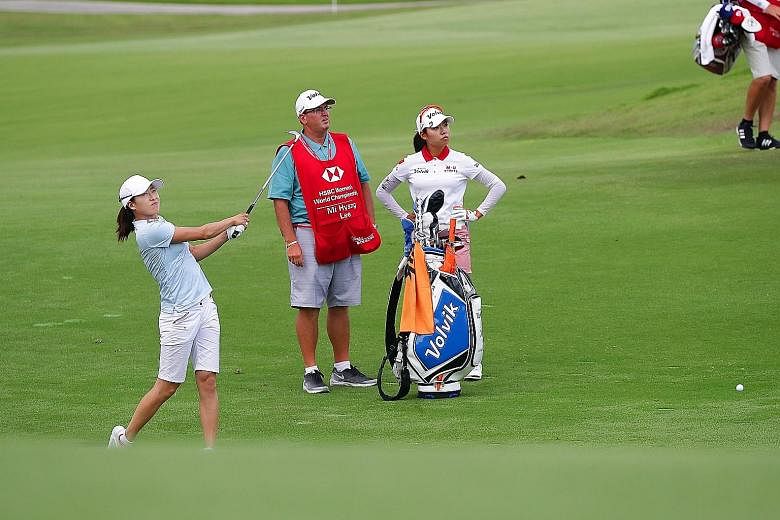 With seven birdies and a seven-under 65 on the opening day of the HSBC Women's World Championship, Jennifer Song (far left) has a two-shot lead against all expectations. The American has missed 61 cuts in 155 starts. Playing partner Lee Mi Hyang card