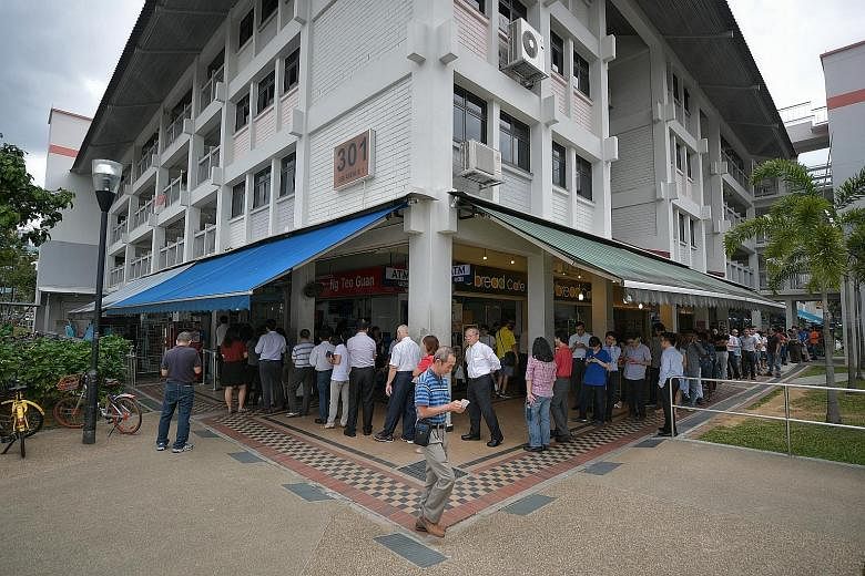 The annual Toto Hongbao Draw, with a top prize of $12 million, drew long queues at several Singapore Pools outlets yesterday, including this one at Block 301, Ubi Avenue 1. Punters hope to strike it rich in the draw tonight. This year's jackpot is le