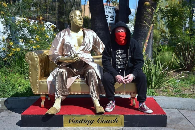 Casting Couch, a statue of Harvey Weinstein on a couch and holding an Oscar, is the work of artists Plastic Jesus (in photo) and Joshua "Ginger" Monroe.