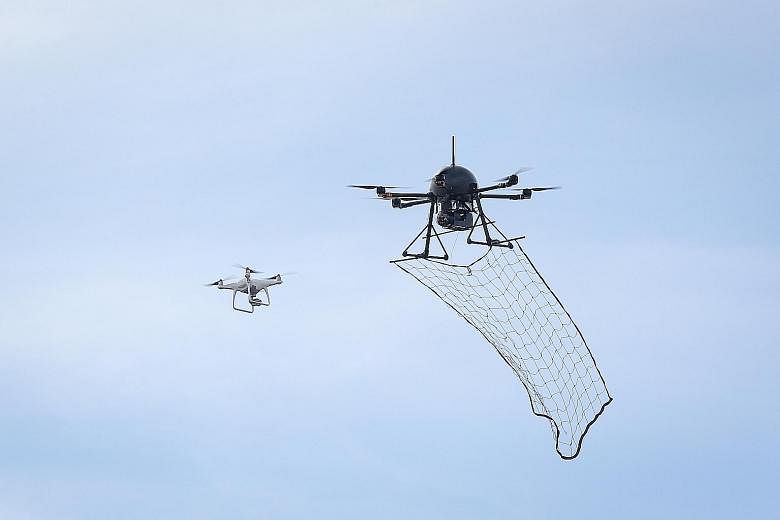 A "drone-catcher" homes in on an errant drone and catches it with a net. Counter-drone systems are among the features of smart airbases of the future.