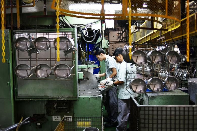 Workers at a refrigerator compressor factory. Last month's lower electronics reading came on the back of slower growth in both factory output and new orders.
