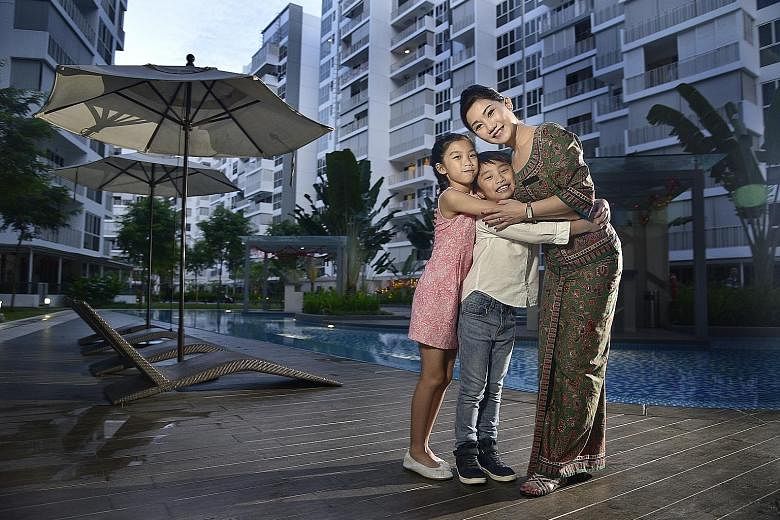 Ms Christina Chia with her daughter Charlize, 11, and son Paxton, eight. Technology such as mobile phones and video chats help her stay in touch with her children when she is away. Being a stewardess also means she does not bring work home, so she is
