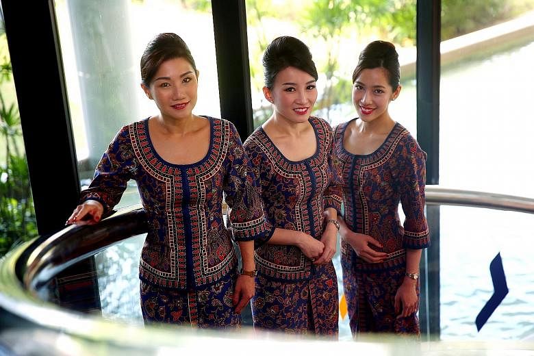 Former cabin crew members who have returned to work with Singapore Airlines include (from left) leading stewardess Christina Chia, 38, and flight stewardesses Anna Ye, 33, and Catherine Yap, 30.