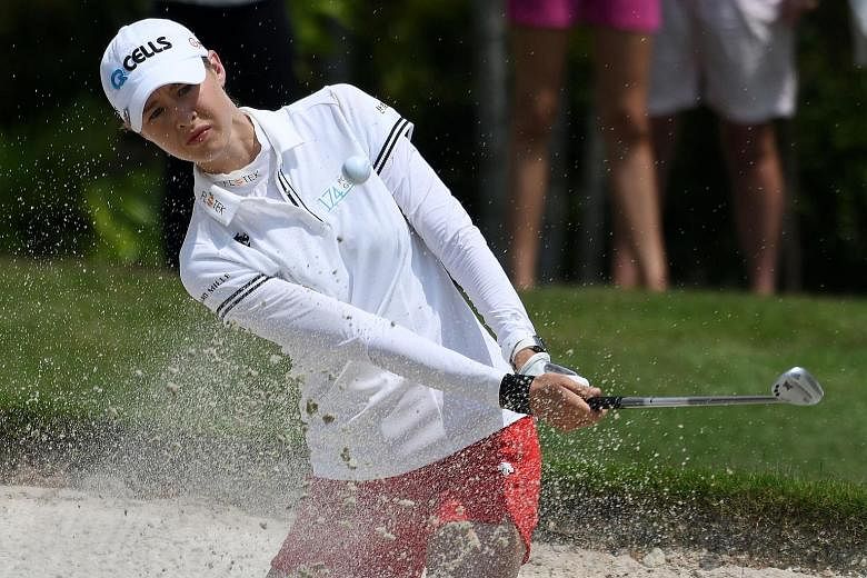 Nelly Korda of the United States hitting a shot from the bunker during the third round of the HSBC Women's World Championship yesterday. The 19-year-old, who is without a win since joining the LPGA last year, takes a one-shot lead over compatriot Dan