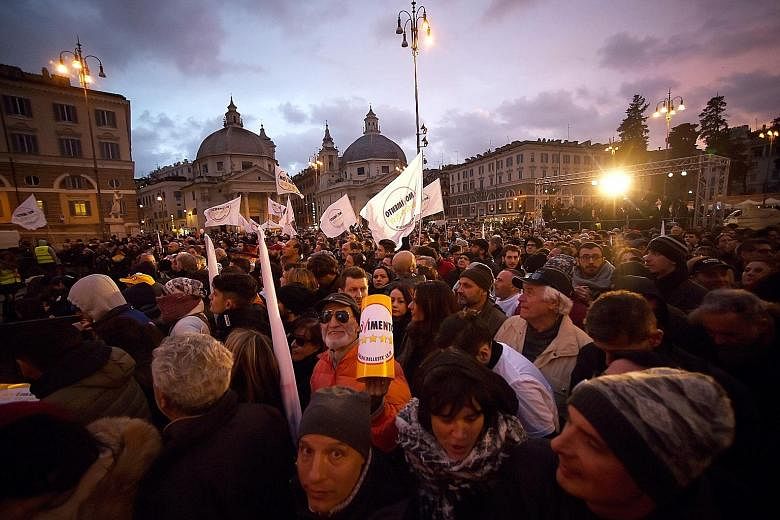 Supporters of the anti-establishment Five Star Movement gathering at the end of the last election campaign meeting by party leader Luigi Di Maio in Piazza del Popolo in Rome last Friday. Campaigning was not allowed yesterday, on the eve of the poll. 