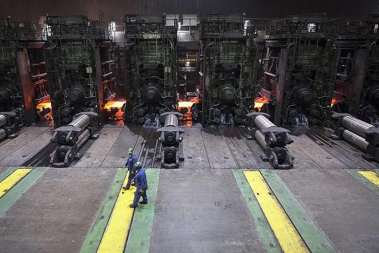 Workers at a South Carolina mill where sheets of hot steel are flattened into rolled steel. President Donald Trump is planning to impose tariffs of 25 per cent on steel imports and 10 per cent on aluminium imports from all countries. The tariffs will