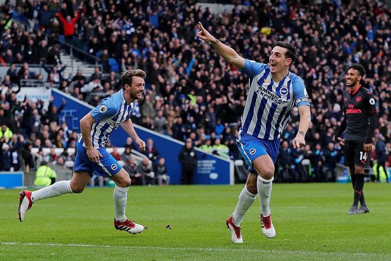 Brighton's Lewis Dunk celebrating scoring their first goal against Arsenal, having rifled home after he was first to react to a knockdown from a corner. The promoted side won 2-1.