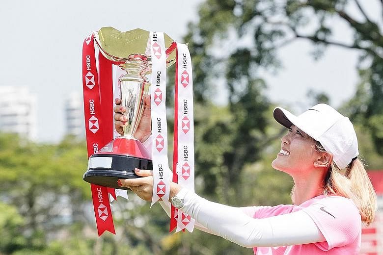 American Michelle Wie, holding aloft the HSBC Women's World Championship trophy, has battled multiple injuries in recent years before she returned to winning ways yesterday.