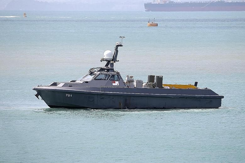 Above: The unmanned surface vessel, now on trial, can be controlled remotely by two operators. Right: Fitted with a towed synthetic aperture sonar system, the USV can be configured for coastal patrols in future.