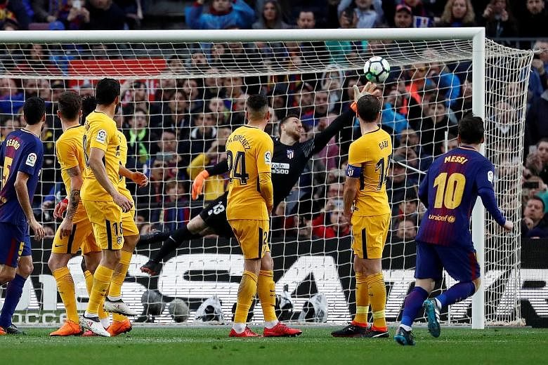 Atletico Madrid players can only watch as Lionel Messi's free kick is struck beyond the despairing dive of goalkeeper Jan Oblak. The goal separated Spain's top two sides, with Barcelona's lead at the top now eight points.