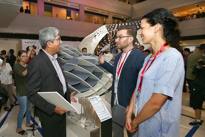 Dr Yaacob Ibrahim talking to Mr Razvan Ghilic-Micu and Ms Jia Xin Chum about their installation Headspace at the Singapore Design Week yesterday.