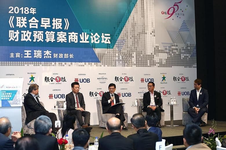 With Finance Minister Heng Swee Keat at the post-Budget forum organised by Chinese daily Lianhe Zaobao yesterday were (from left) Singapore Business Federation chairman Teo Siong Seng, Lianhe Zaobao and Lianhe Wanbao editor Goh Sin Teck, Singapore Ch