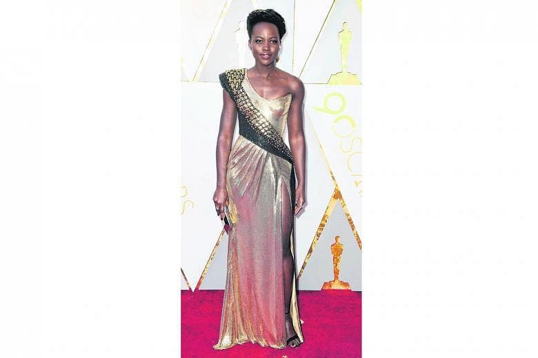 Lupita Nyong'o rarely gets it wrong on the red carpet and this year is no exception. Her form-fitting custom atelier Versace gown looks like liquid armour and gives viewers serious throwbacks to her tough warrior princess role in Black Panther.