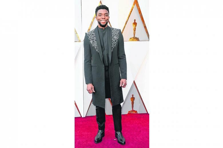 Black Panther star Chadwick Boseman scores serious style points for leaving his tuxedo at home and turning up on the red carpet in a knee-length embellished coat jacket instead. It is just bedazzled enough to be interesting, but sleek enough to fit the fo