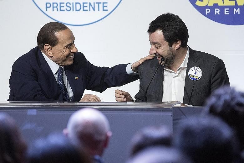Mr Silvio Berlusconi (left), leader of the Forza Italia party, with Mr Matteo Salvini, leader of the eurosceptic party League, during a centre-right coalition general election campaign rally in Rome on March 1. The League was among the parties that d