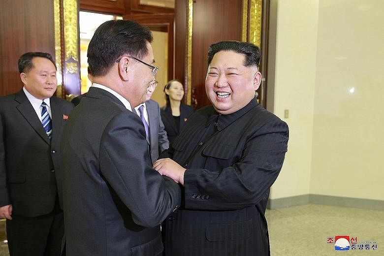 Above: North Korean leader Kim Jong Un (right) welcoming members of the South Korean delegation during their meeting in Pyongyang on Monday. It was his first meeting with top South Korean officials since he assumed power in 2011. Left: The visiting S