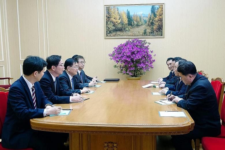 Above: North Korean leader Kim Jong Un (right) welcoming members of the South Korean delegation during their meeting in Pyongyang on Monday. It was his first meeting with top South Korean officials since he assumed power in 2011. Left: The visiting S